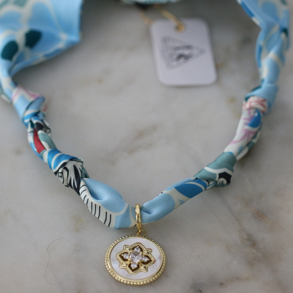 Blue and seafoam scarf necklace with white enamel floral charm, view 4