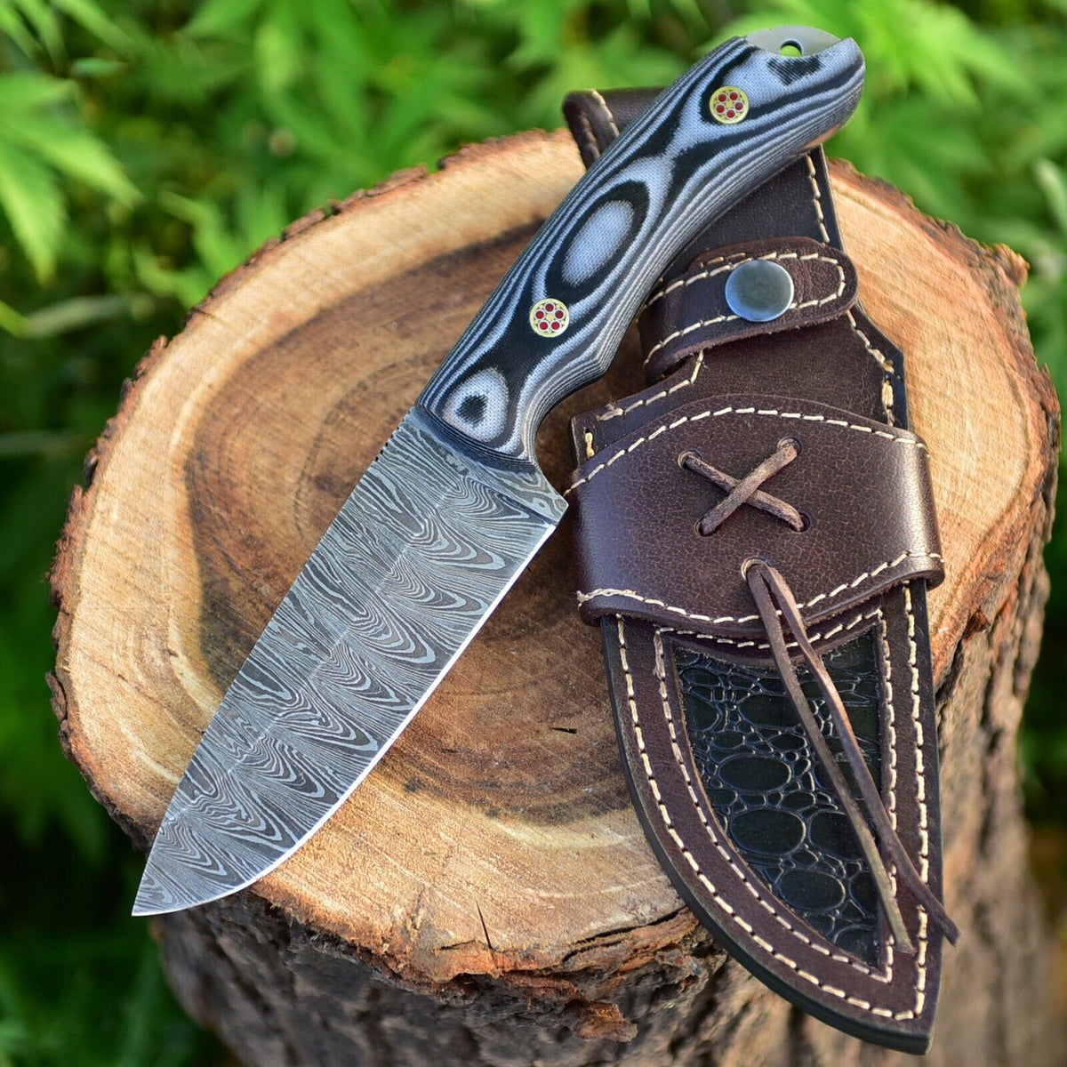 Damascus skinning knife with a layered multi-color sheet handle