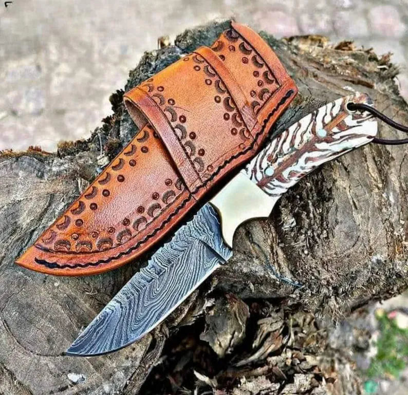 Damascus steel knife with pine cone handle, brass bolster, and rope-style leather sheath