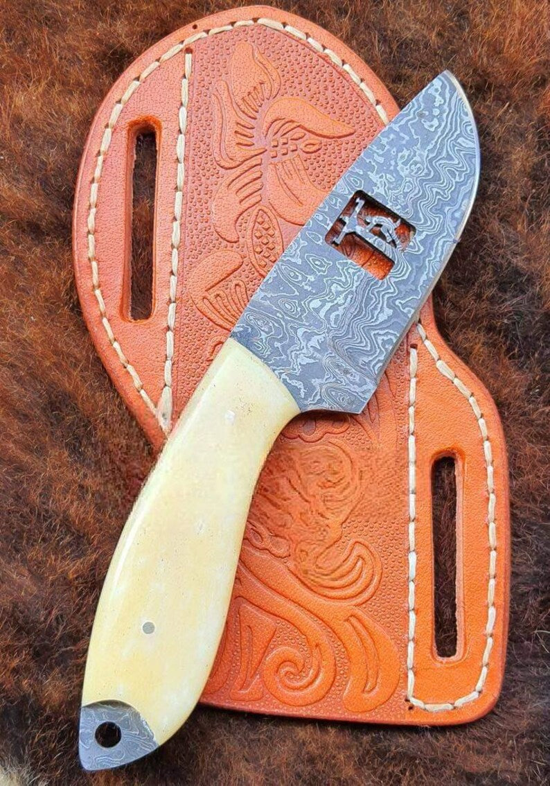 Damascus cowboy knife with camel bone handle and rope leather sheath