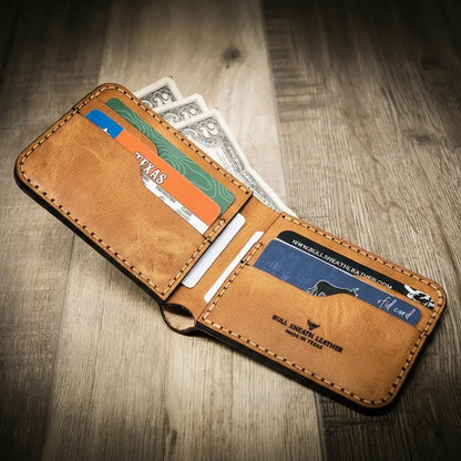 Saddle tan leather bifold wallet with burnished edges
