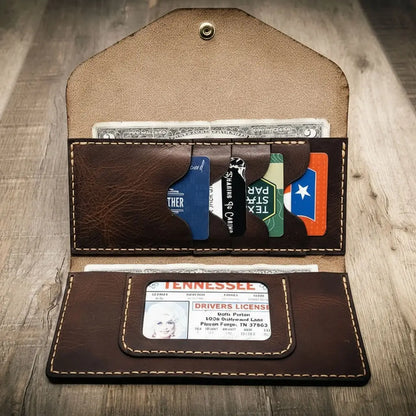 Saddle tan wrap-around leather clutch wallet folded flat, view 4