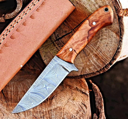 Damascus hunting knife with polished rosewood handle beside a leather sheath