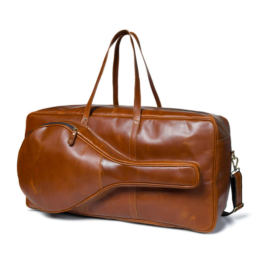Tan buffalo leather duffle bag with top handle and shoulder strap