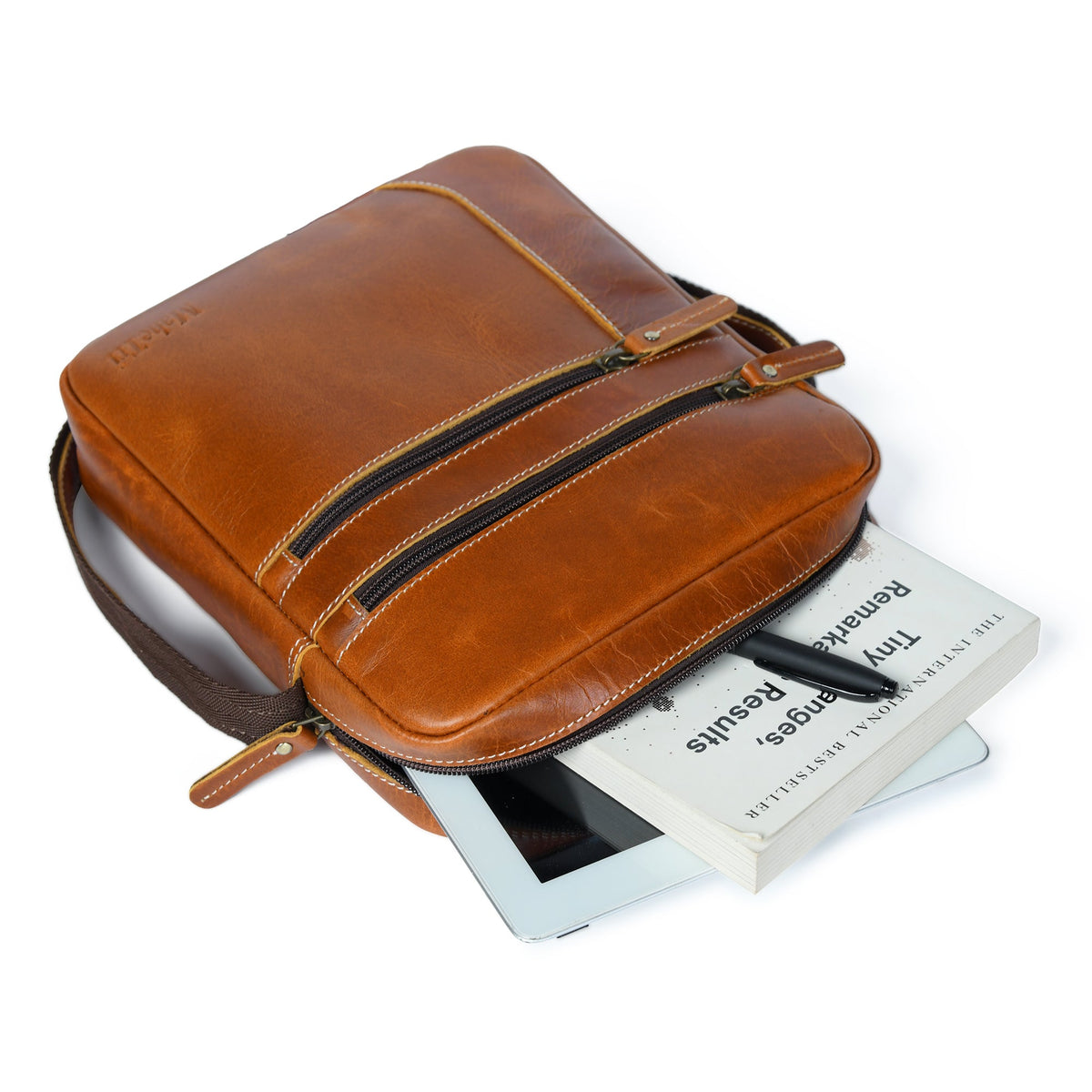 Tan buffalo leather compact messenger bag with front zip pockets, view 2