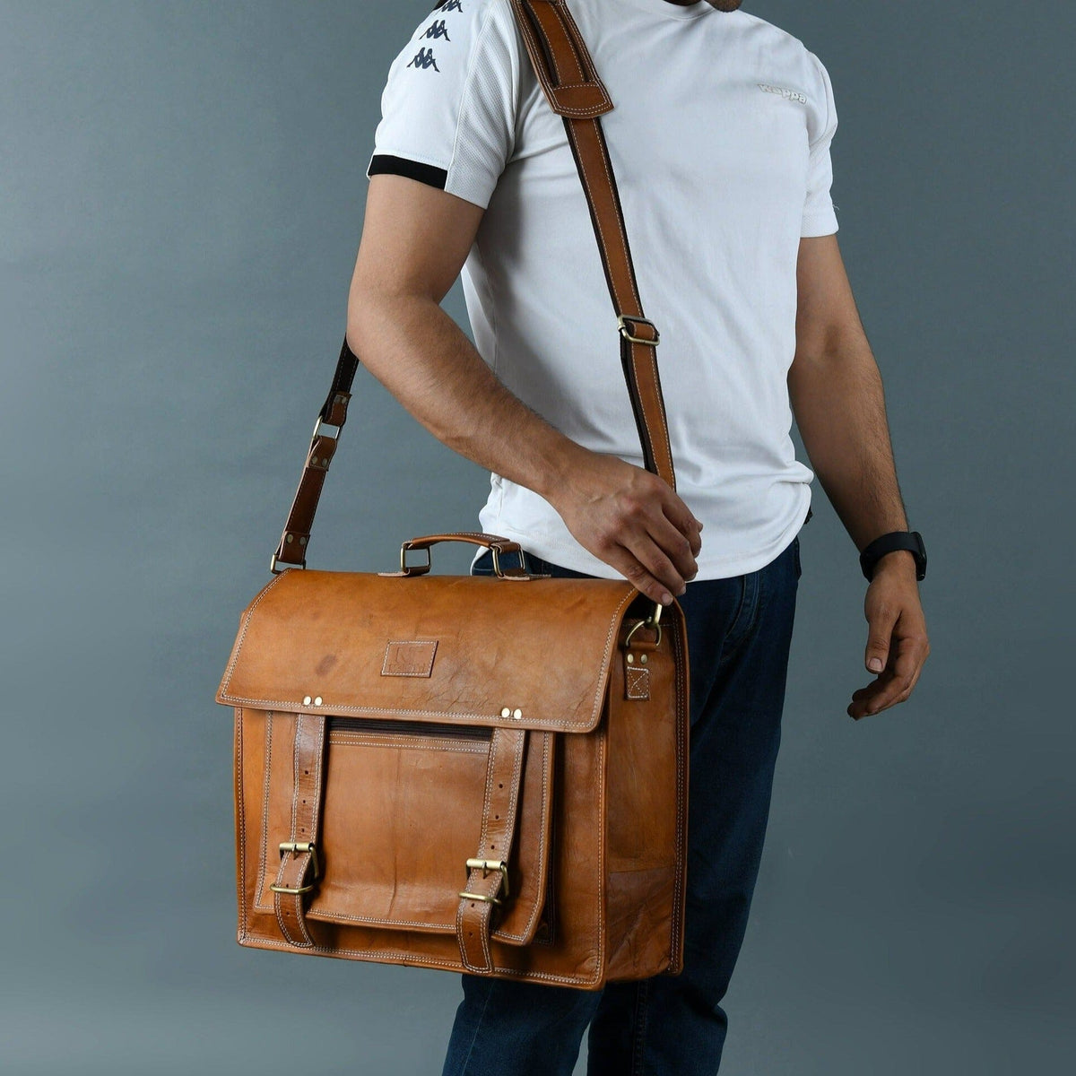 Tan brown leather messenger bag with brass buckles and large front pocket, view 3