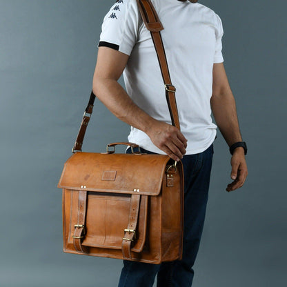 Tan brown leather messenger bag with brass buckles and large front pocket, view 3