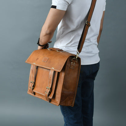 Tan brown leather messenger bag with brass buckles and large front pocket, view 2