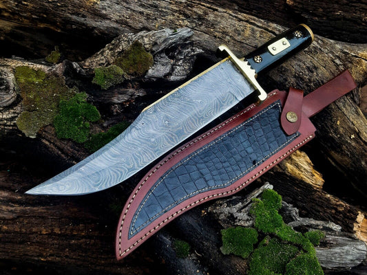Long Damascus Bowie knife with a dark buffalo horn handle and brass guard
