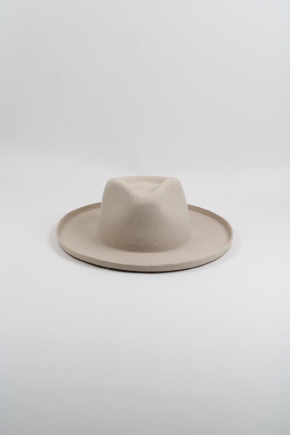 Ivory wool felt hat with a teardrop crown and pencil-rolled brim