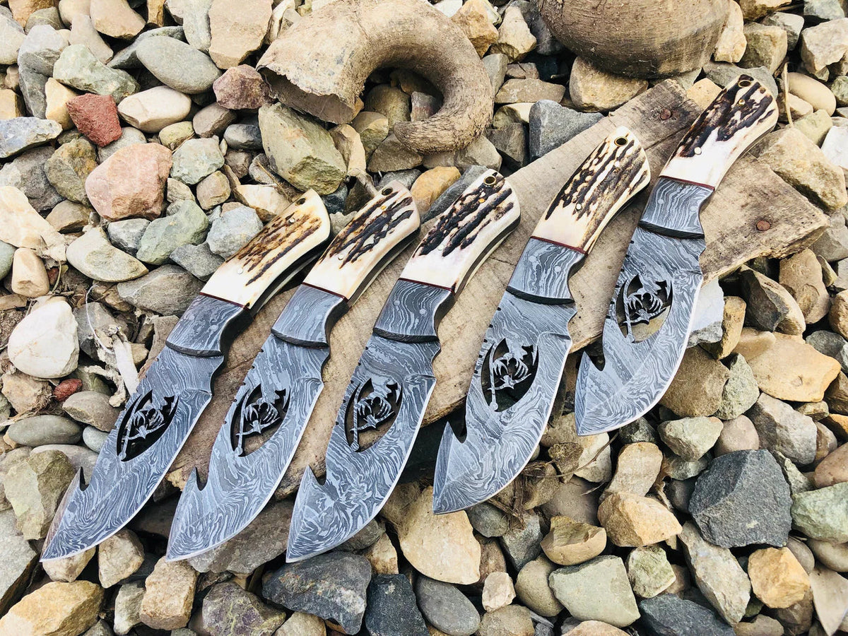 Wire-cut Damascus steel skinning knife with antler horn handle and leather sheath