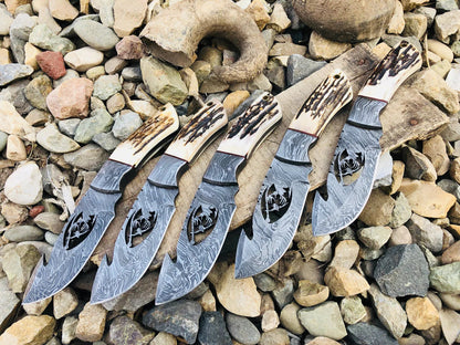 Wire-cut Damascus steel skinning knife with antler horn handle and leather sheath