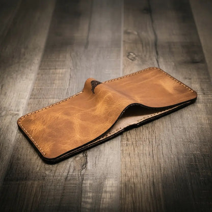 Saddle tan leather bifold wallet open to show eight card slots, view 2