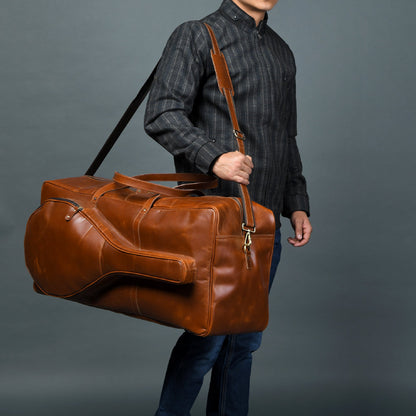 Tan buffalo leather duffle bag with top handle and shoulder strap, view 2