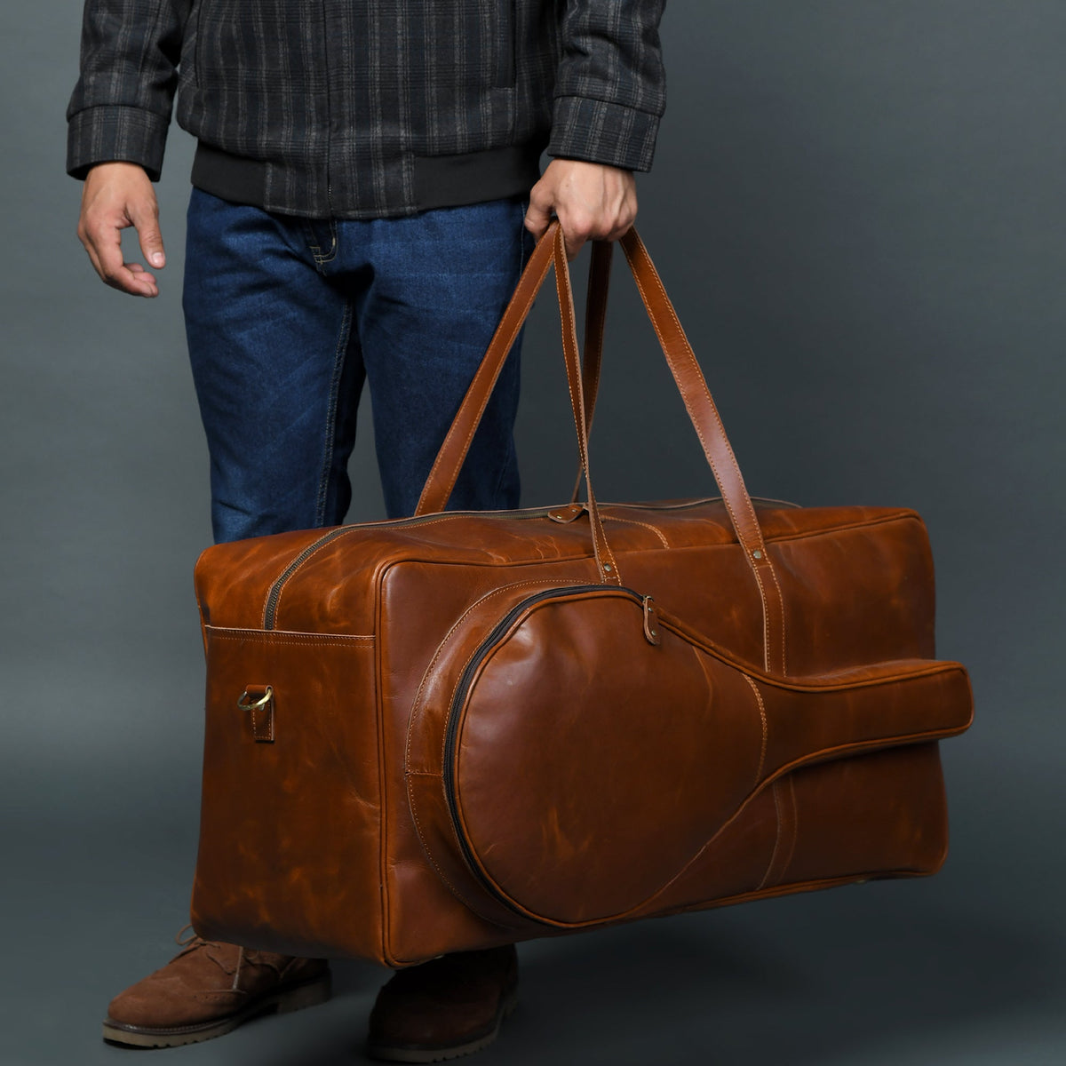 Tan buffalo leather duffle bag with top handle and shoulder strap, view 3
