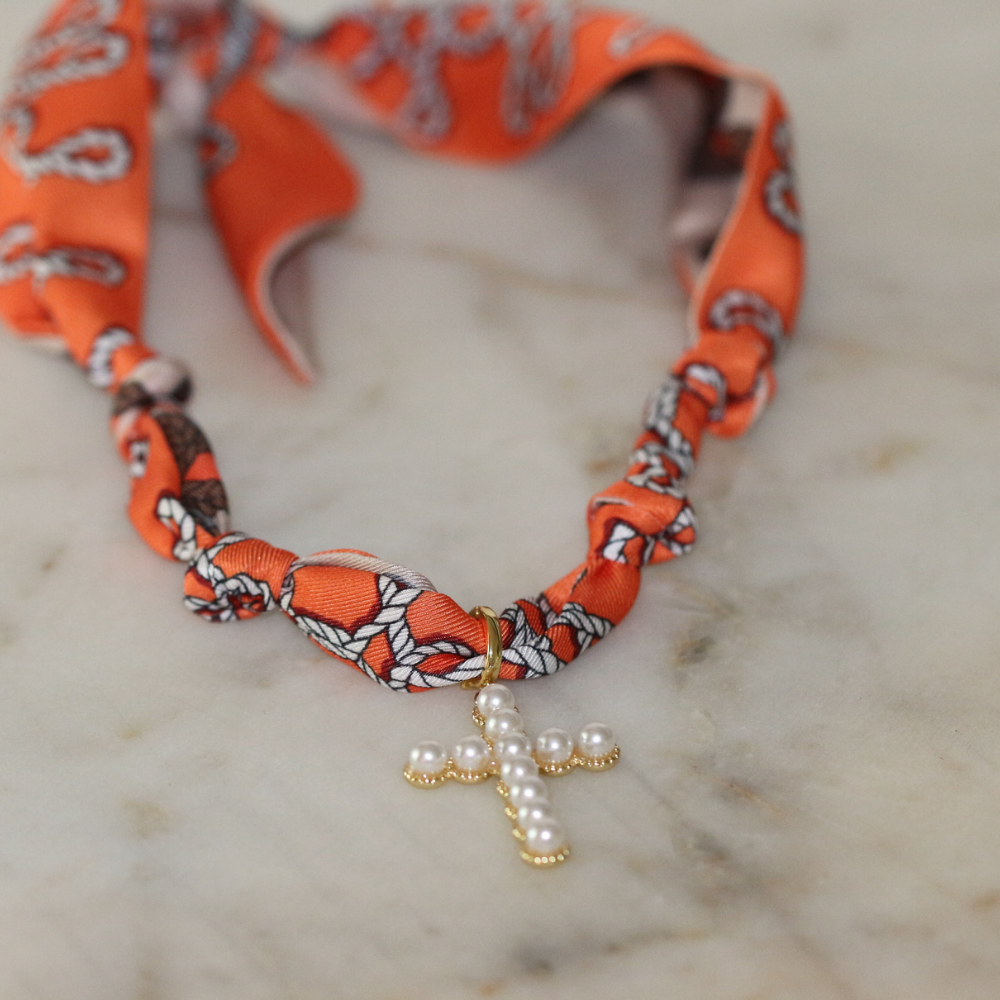 Orange scarf necklace with gold framed pearl cross