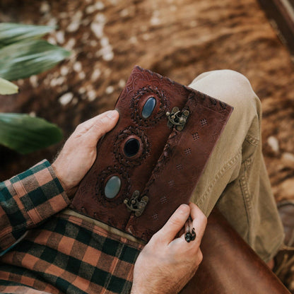 Vintage leather journal with three embossed stones on the cover, view 2