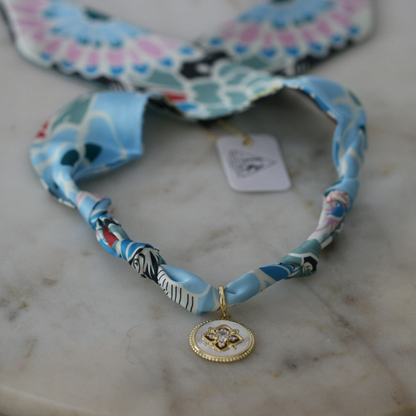Blue and seafoam scarf necklace with white enamel floral charm, view 3