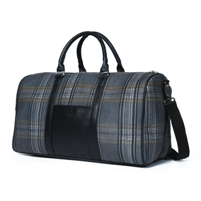 Grey plaid canvas duffle bag with leather trim and shoulder strap, view 2