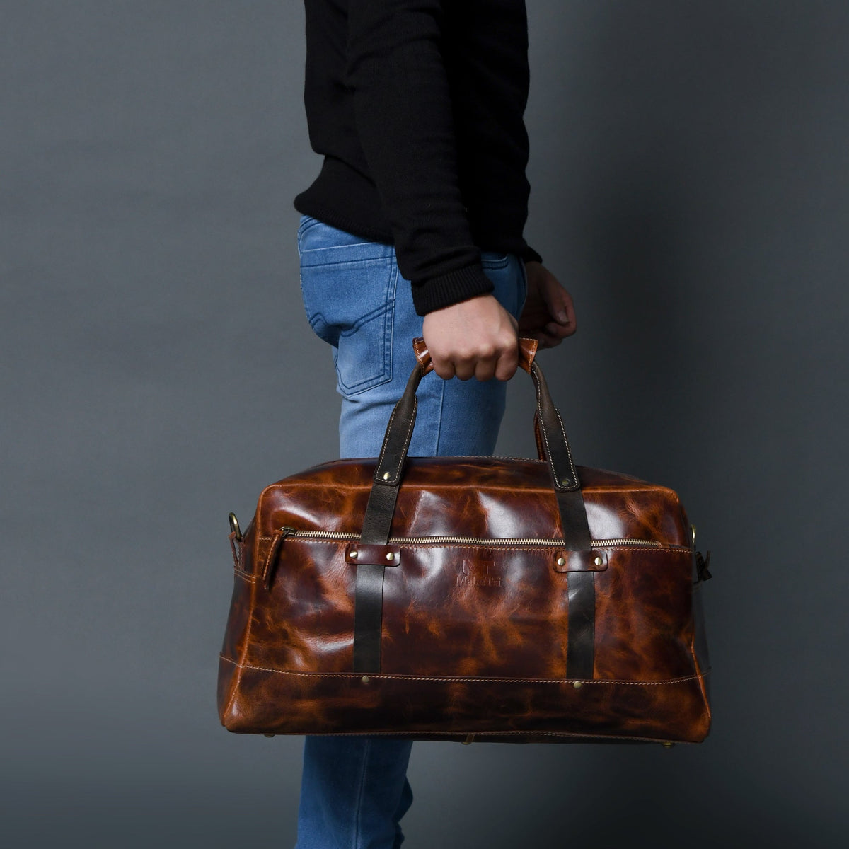 Saddle tan buffalo leather carry-on duffle with black handles and shoulder strap, view 3