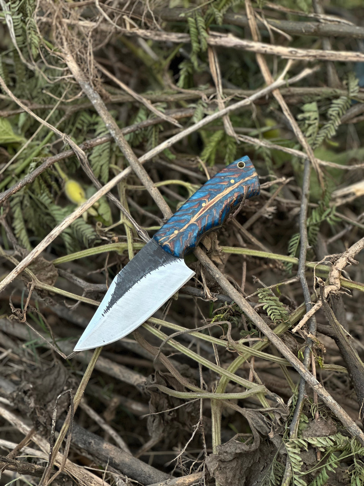 D2 steel hunting knife with pine cone resin handle and leather sheath