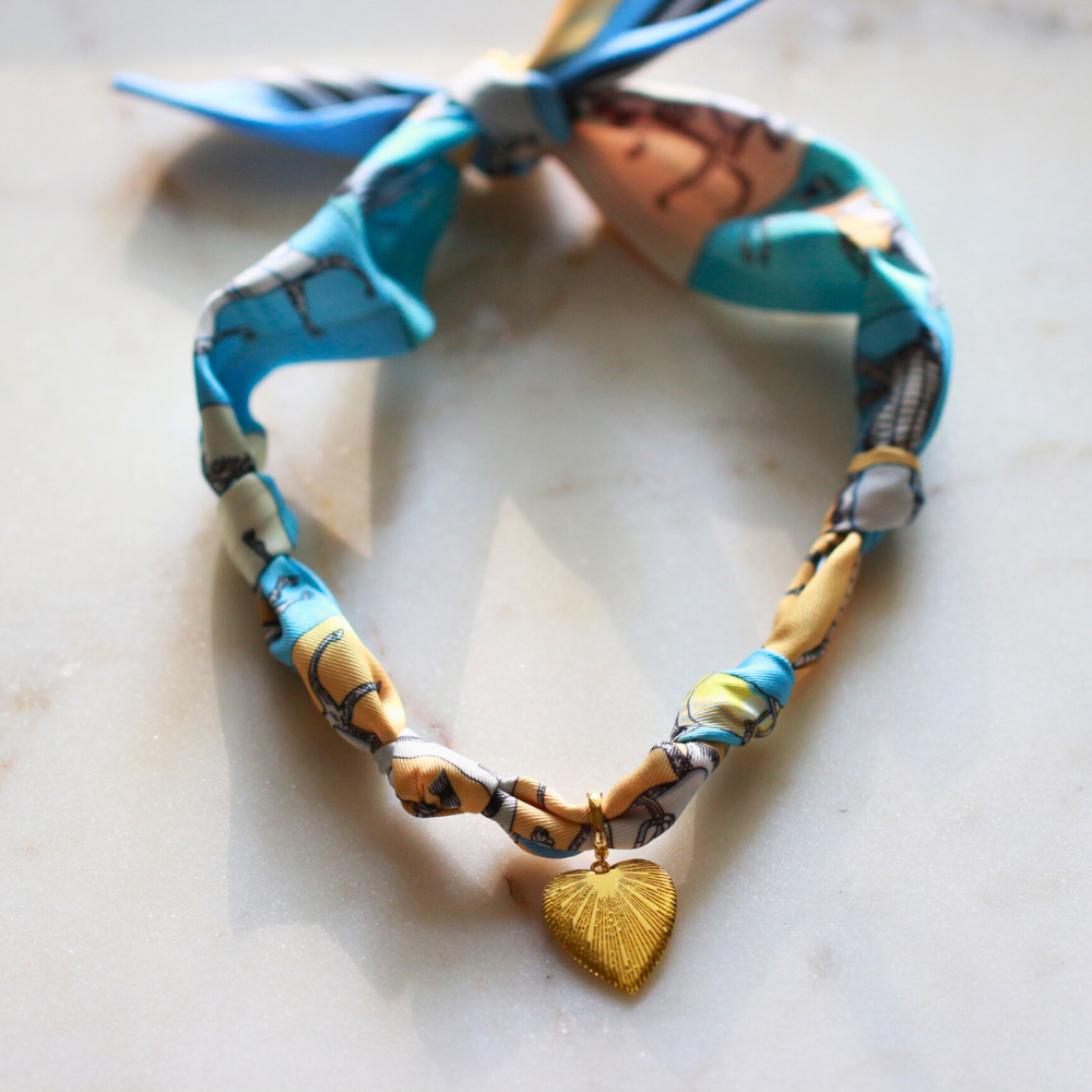 Blue horse print silk scarf necklace with gold charm, view 7