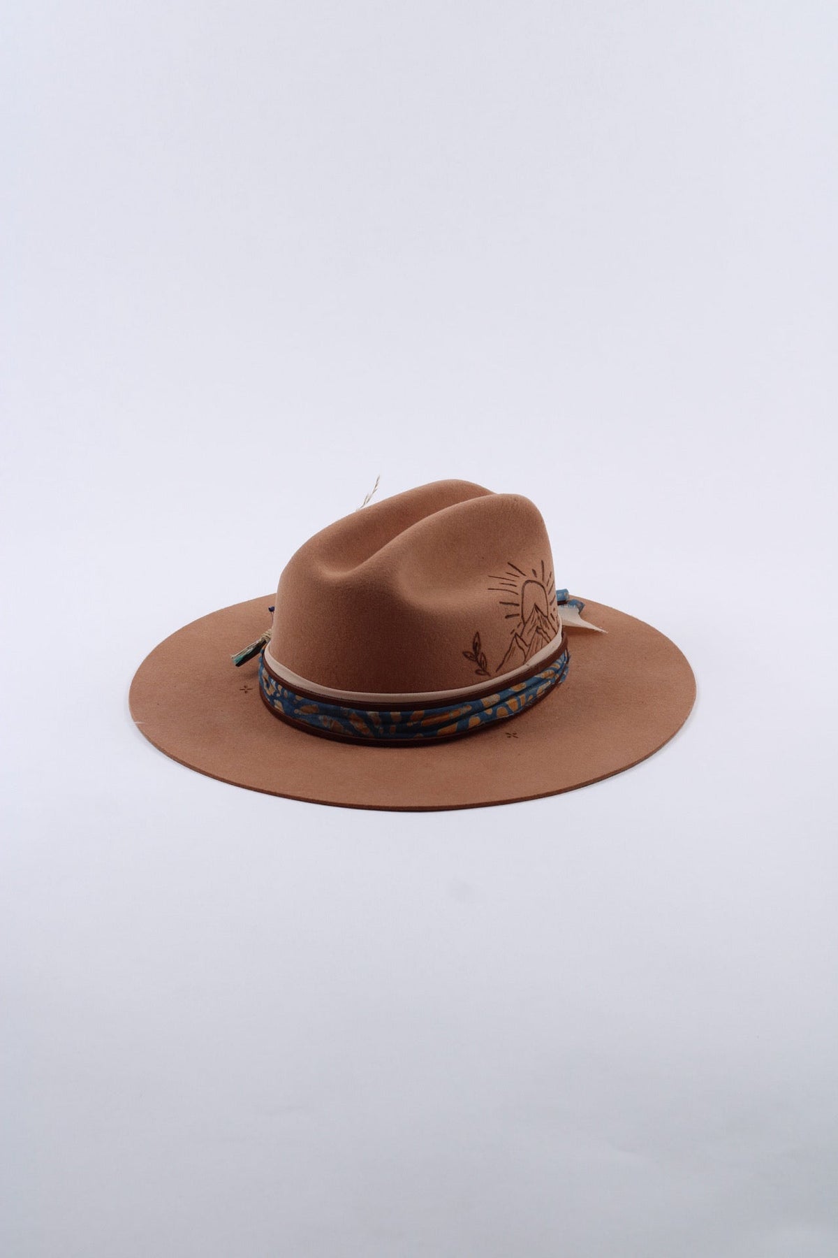 Tan wool flat brim cattleman hat with a hand-burned sunset and mountain design