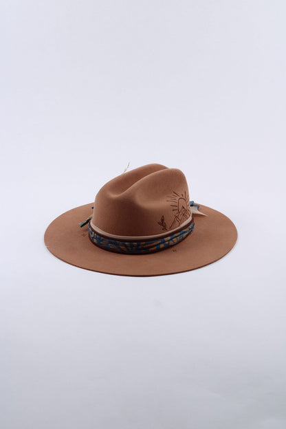 Tan wool flat brim cattleman hat with a hand-burned sunset and mountain design