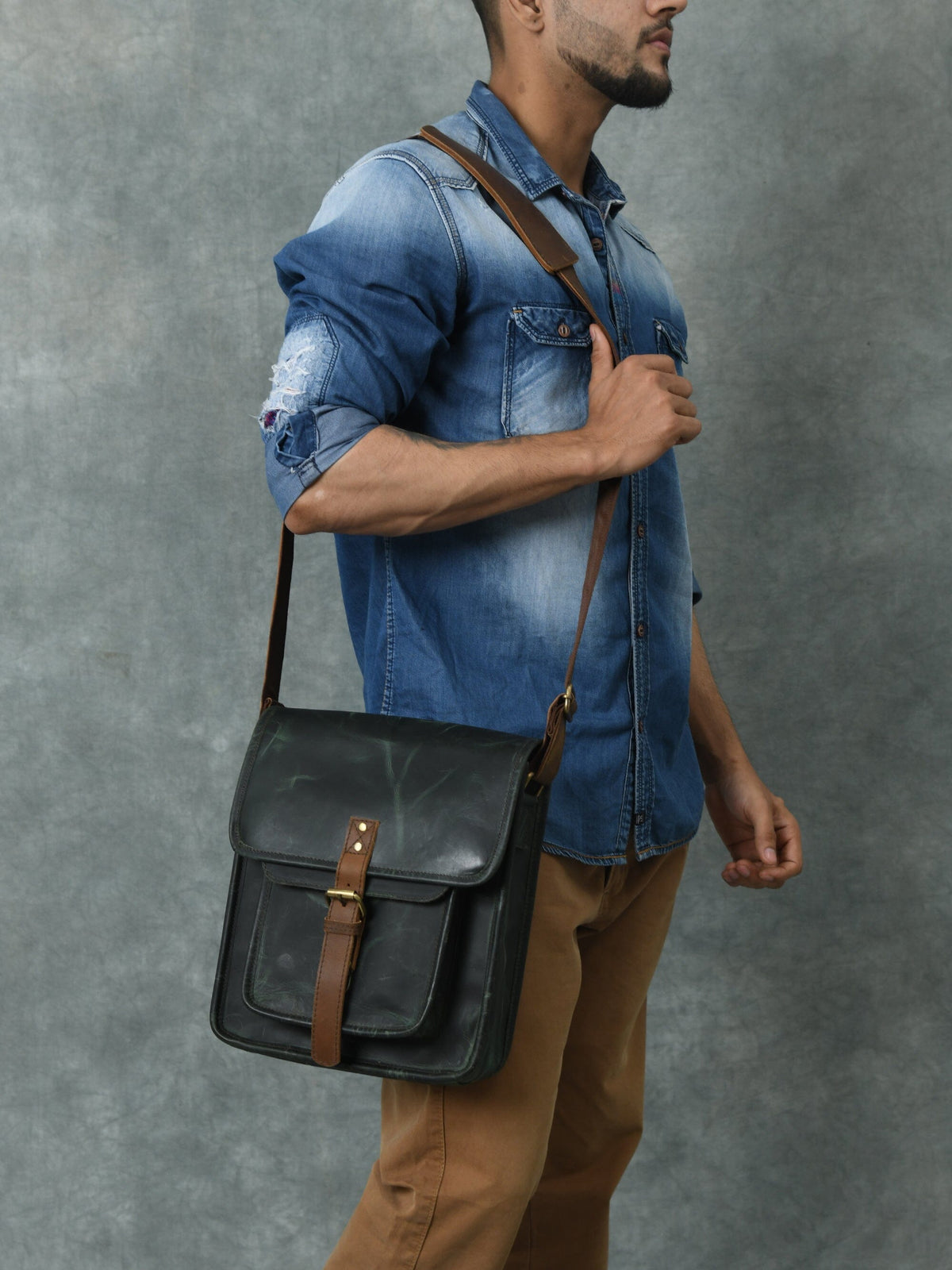 Green buffalo leather messenger bag with brown accents and brass push clips, view 2