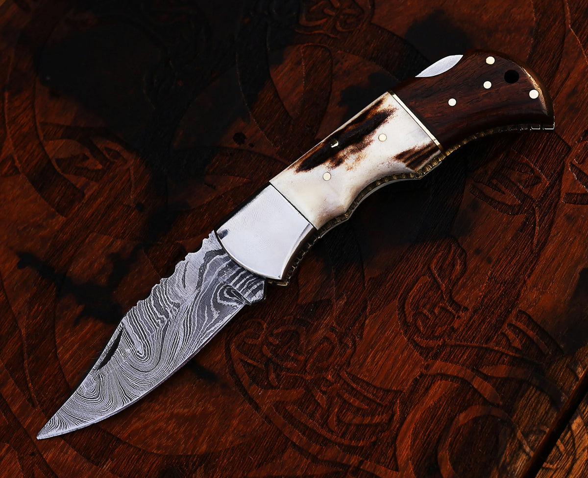 Damascus folding pocket knife with antler horn and camel bone handle and leather sheath