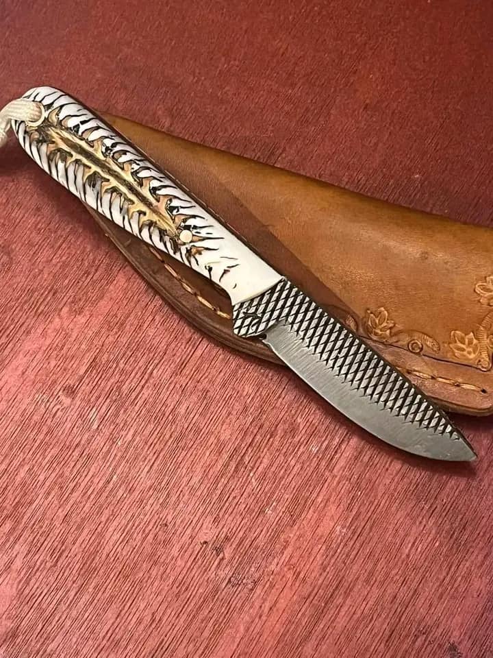 Rasp steel Buckaroo belt knife with contoured epoxy pine cone handle and leather sheath