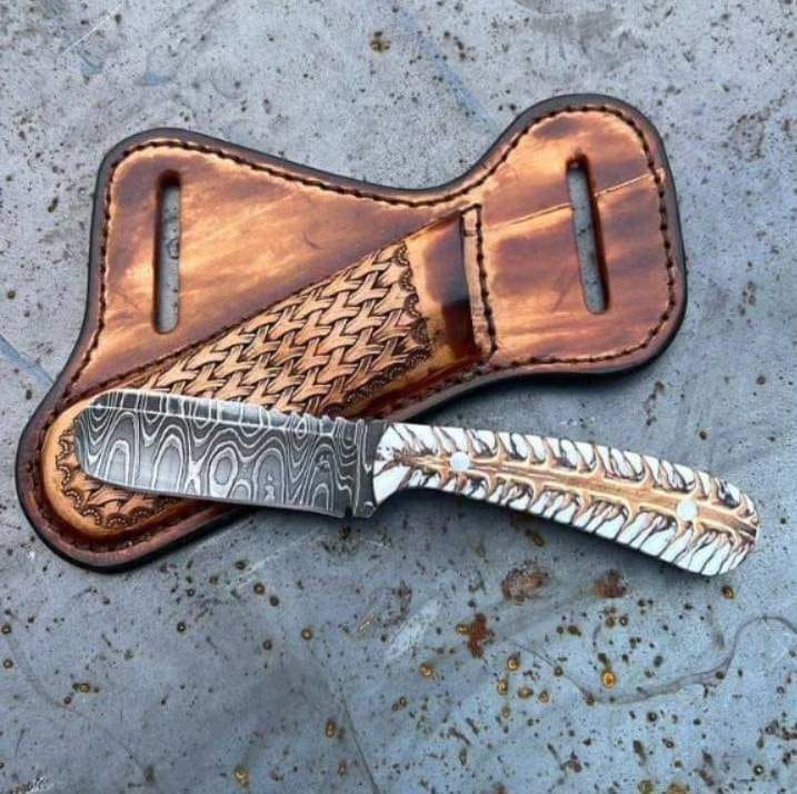 Damascus bull cutter knife with pine cone handle and leather sheath