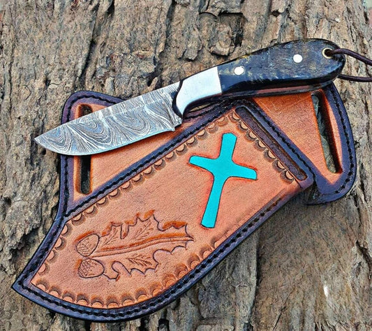 Damascus bull cutter knife with a sheep horn handle and leather sheath