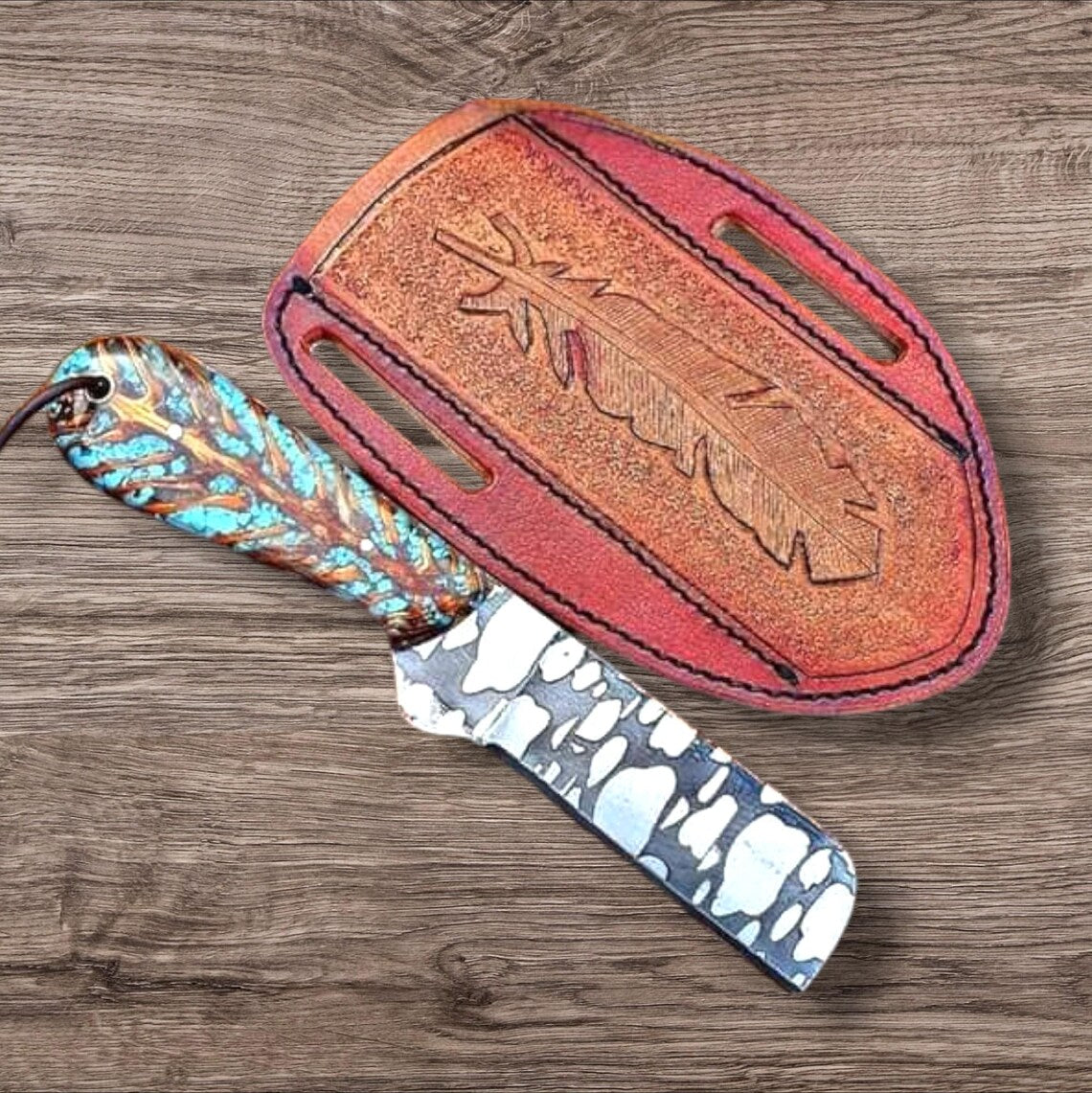 Etched J2 steel bull cutter knife with pine cone composite handle and leather sheath