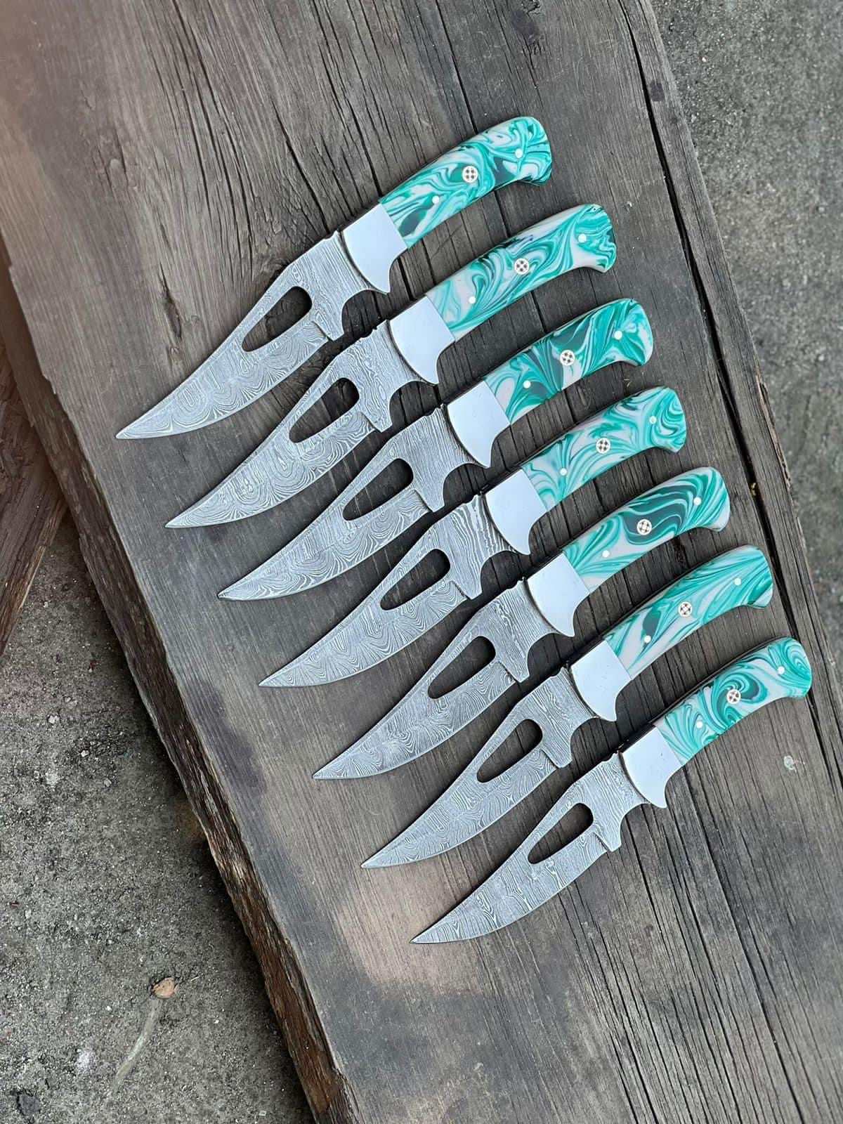 Damascus hunting knife with resin handle and steel bolster