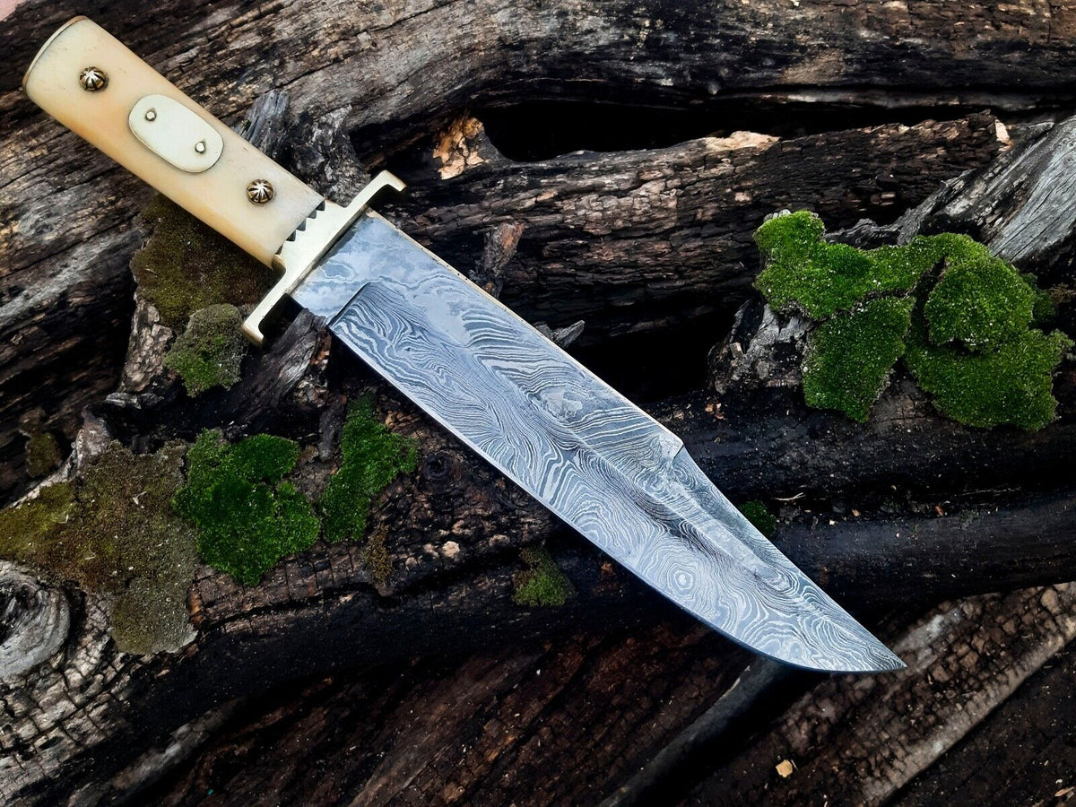 Damascus cowboy Bowie knife with a polished camel bone handle and brass guard