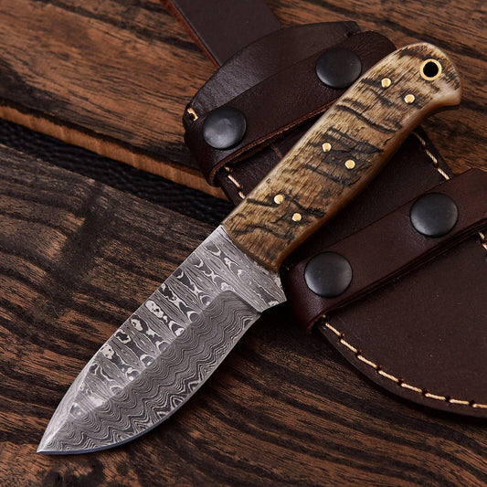 Damascus steel skinning knife with a curved sheep horn handle