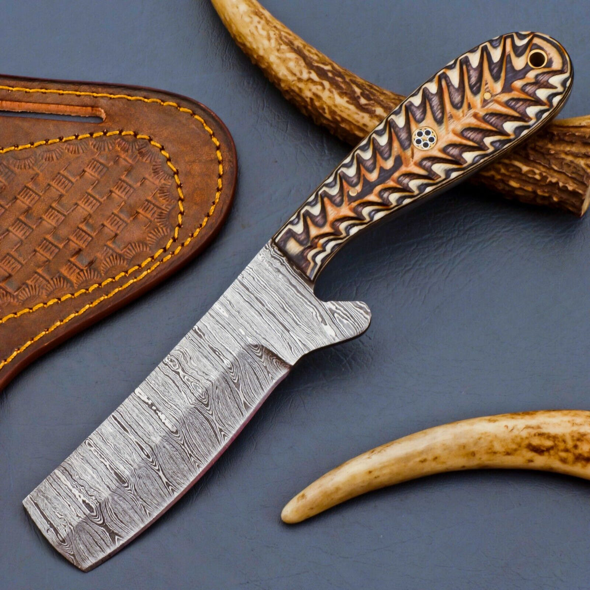 Damascus steel bull cutter knife with brown Pakka wood handle and leather sheath