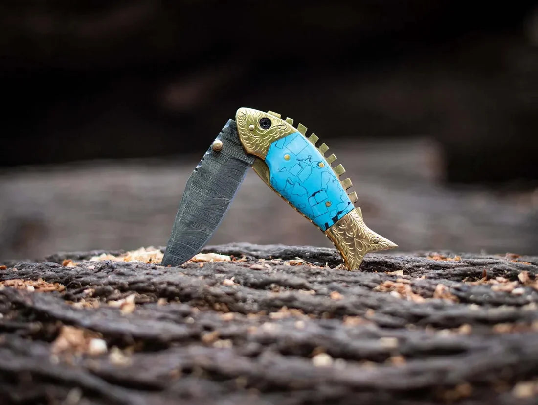 Folding knife with fish-shaped Damascus blade, epoxy resin and brass handle