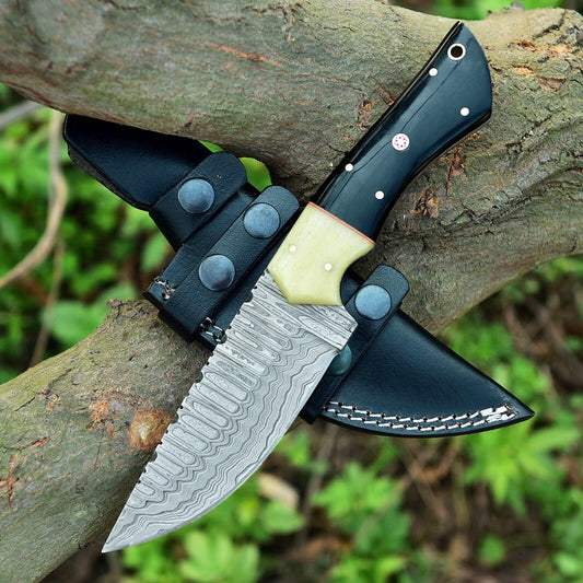 Damascus skinning knife with a dark buffalo horn and pale camel bone handle