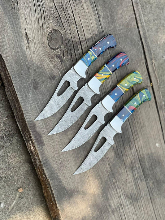 Small Damascus hunting knife with resin handle and steel bolster