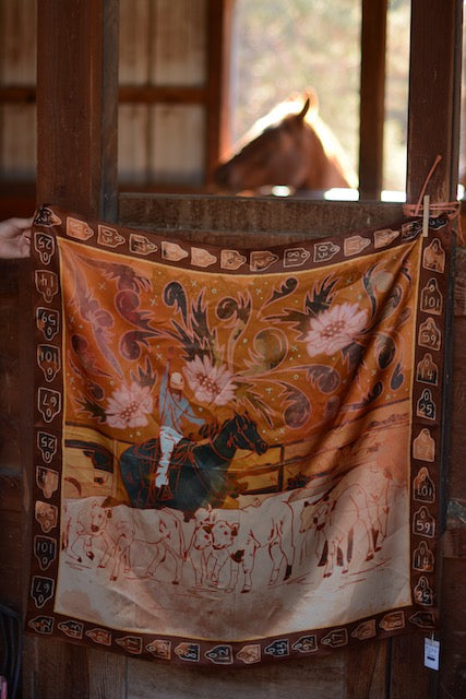 Rust and orange silk wild rag showing a cowgirl roping calves for branding, view 4