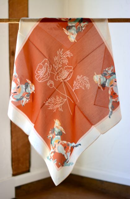 Red silk wild rag with poppies, a cowgirl in each corner and a cream border, view 2