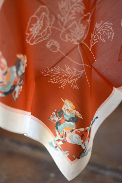 Red silk wild rag with poppies, a cowgirl in each corner and a cream border, view 3