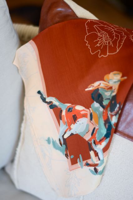 Red silk wild rag with poppies, a cowgirl in each corner and a cream border, view 4