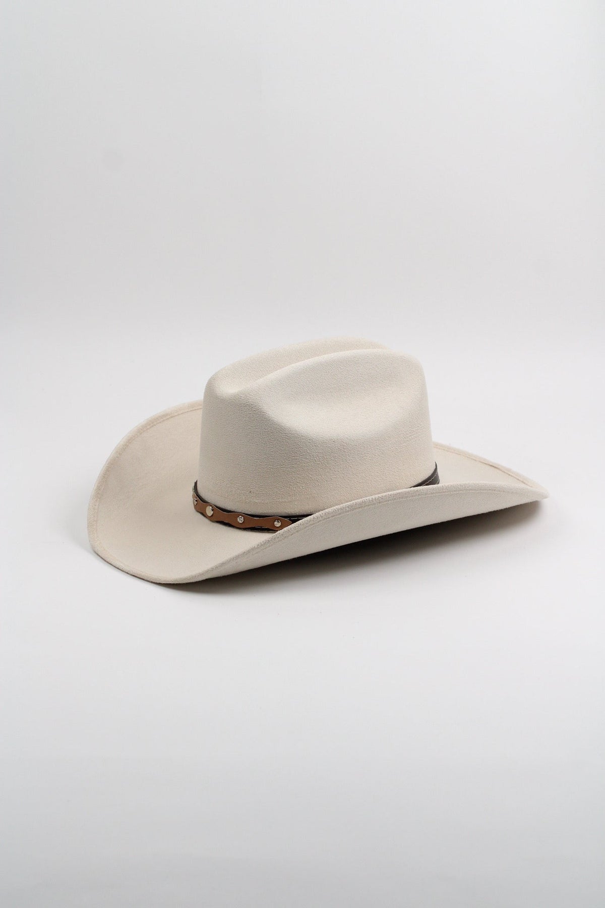 Ivory vegan suede cowboy hat with a lifted brim and faux leather band