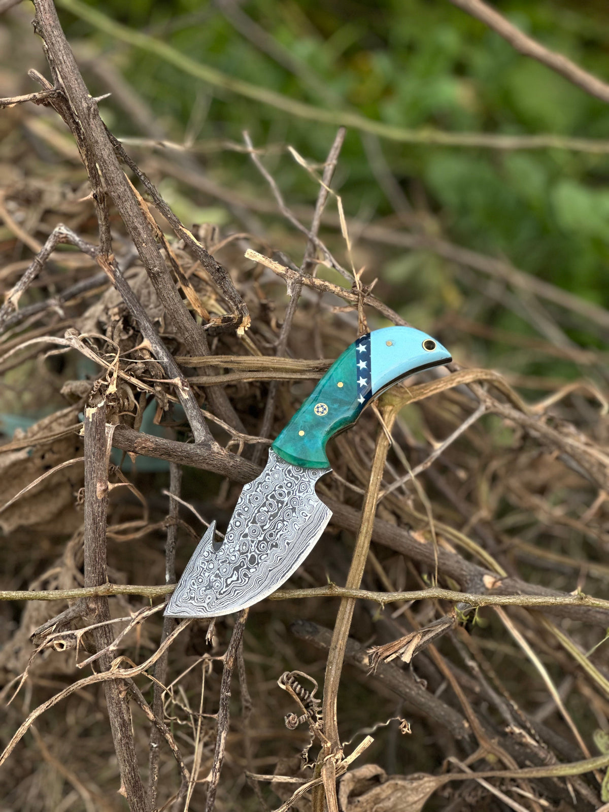 Damascus guthook skinning knife with colored resin handle and leather sheath