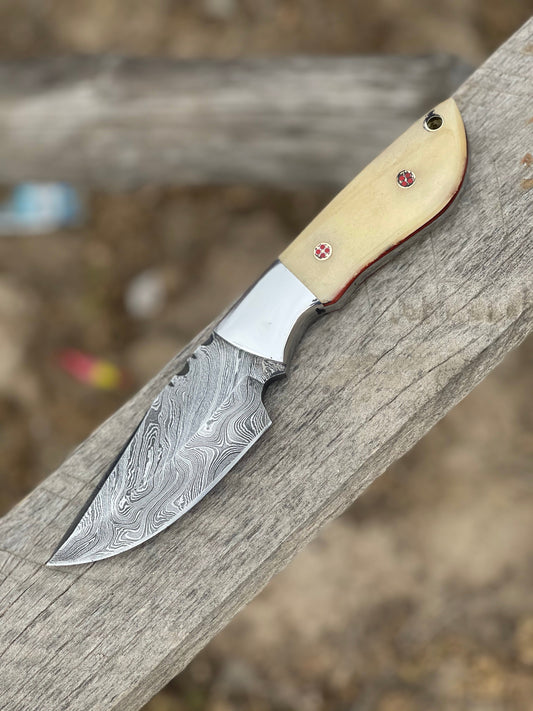Damascus skinning knife with camel bone handle, steel bolster and leather sheath