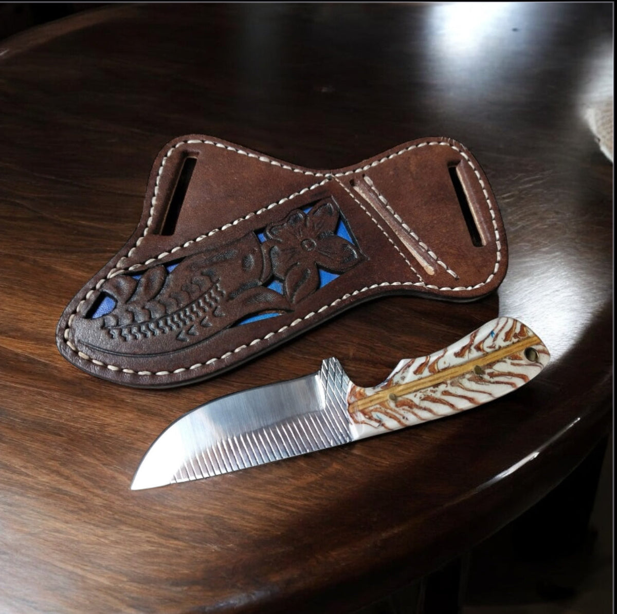 Rasp steel belt knife with stabilized pine cone handle and leather sheath