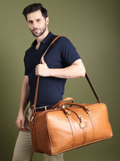 Tan buffalo leather duffle bag with brass hardware and shoulder strap, view 3